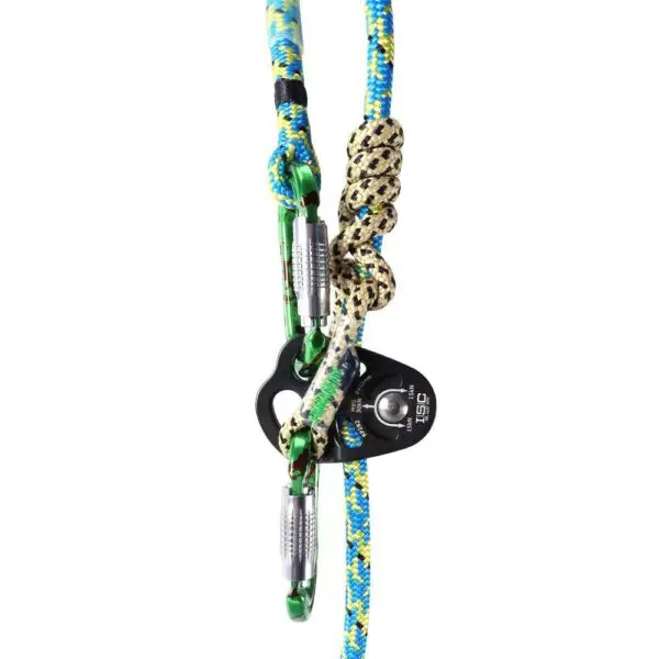 A close-up of a climbing setup featuring two colorful climbing ropes, two Omega Pacific Raider+ Aluminum Keylock 3-Stage Quik-Lok Radioactive, and a black pulley device. One rope has a blue and green pattern, while the other has a beige and black pattern. The carabiners and pulley are securely attached.