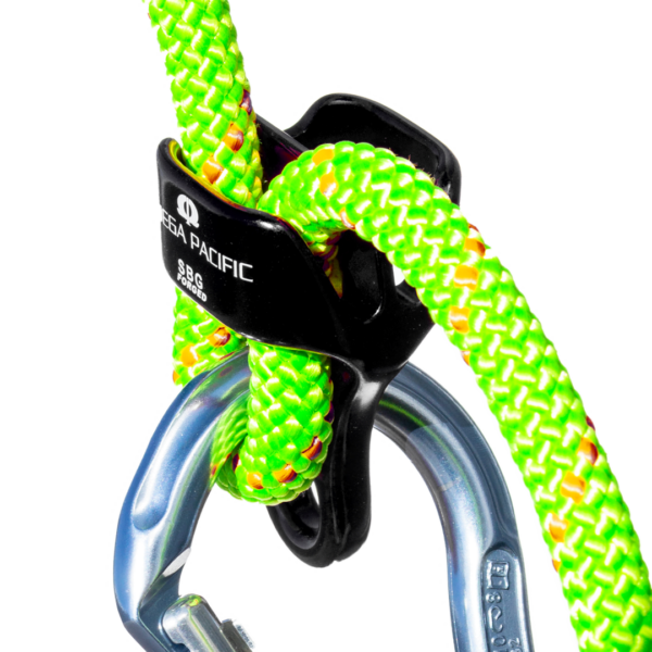 Close-up of a bright green and yellow climbing rope threaded through a black belay device and attached to a metal carabiner. The brand name "Omega Pacific SBGFG Belay/Rappel Device" is visible on the belay device.