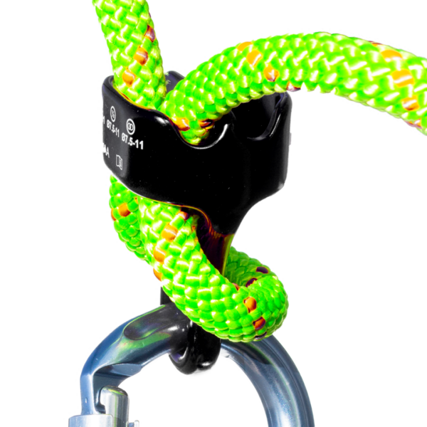 Close-up image of a vibrant green and yellow braided climbing rope secured with an Omega Pacific SBGFG Belay/Rappel Device. A metal locking carabiner is attached to the device, ensuring safety. The background is blurred to emphasize the climbing gear.