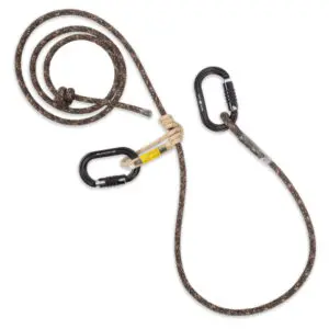 A coiled brown Ape Canyon Outfitters 9.5mm Ghillie Lineman Belt Kit with black flecks, attached to two black carabiners. One part of the rope forms a loop secured with a knot, while the other is coiled loosely with a carabiner clipped on. The carabiners have yellow safety warnings.