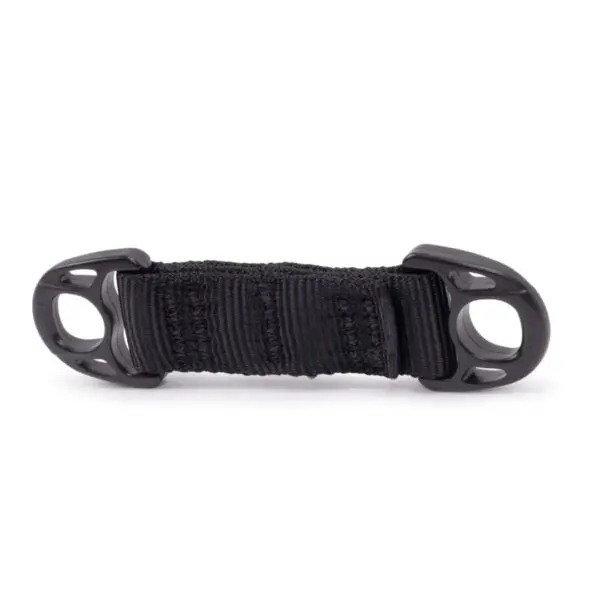 A black nylon loop handle with stitching details, featuring two plastic D-rings at each end. The Ape Canyon Outfitters Lanyard Minder appears sturdy and designed for attaching to various items for carrying or securing purposes. The plastic components have rounded edges and multiple slots.