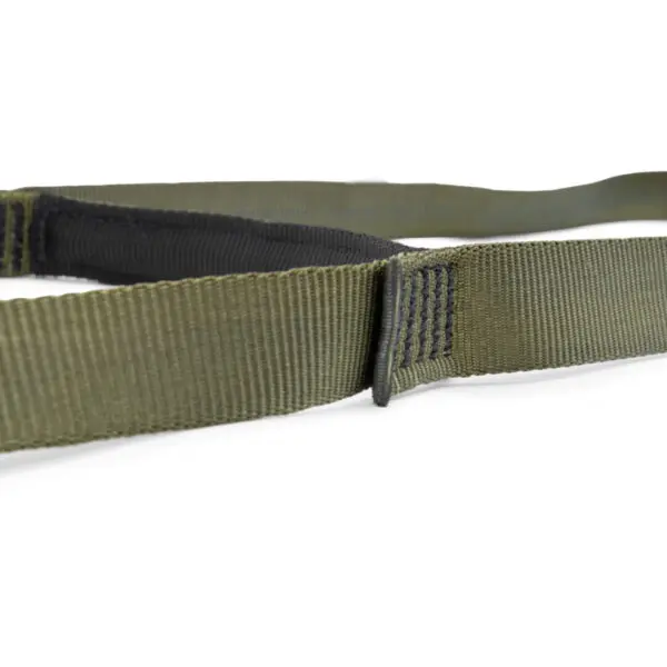 Close-up image of a green military-style nylon strap with black stitching on a white background. The Ape Canyon Outfitters 2 Step Aider appears rugged, with frayed edges and heavy-duty construction, indicating it's designed for durability and strength.