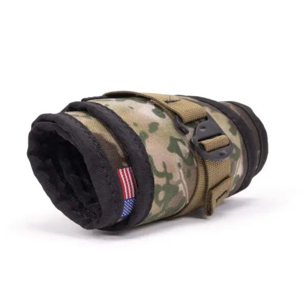 A rolled-up Ape Canyon Outfitters Lazy Hunter Band Obskura Transitional with a black trim and a small American flag patch sewn on the side. The pouch has a strap with a buckle, securing it in a compact form.