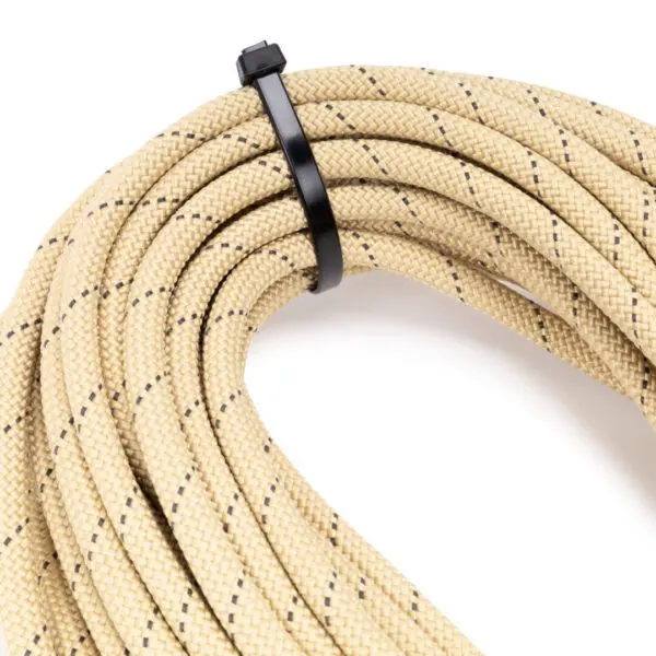 The Ape Canyon Outfitters Rogue 9.5mm is secured with a black plastic tie. The rope appears to be made of a braided material and is neatly bundled in a circular shape. The background is white.