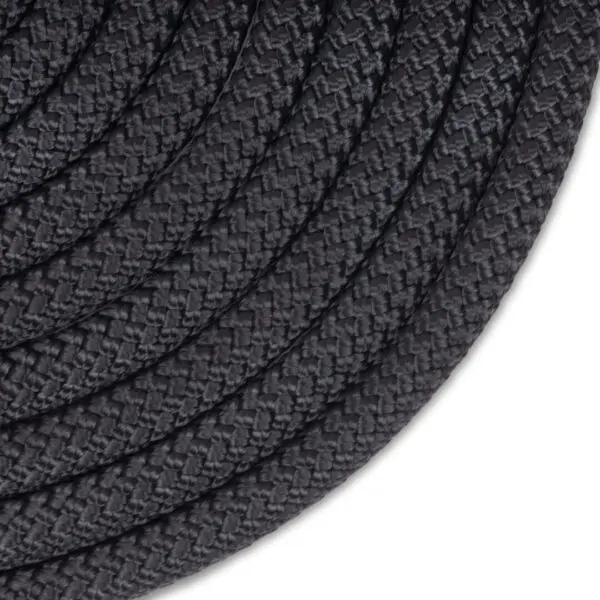 A close-up image of a coiled grey, braided Ape Canyon Outfitters 9.5mm Raven. The texture of the rope is prominent, showing the interwoven fibers that create a detailed pattern. The coils are neatly wound in a circular arrangement, filling most of the image.
