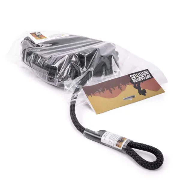 A packaged Ape Canyon Outfitters 9.5mm Raven With Squatch Splice is shown. The packaging features an illustration of a mountain landscape with the label "Recon Outfitter." The strap is coiled inside the clear plastic wrapping, and a looped end extends out.