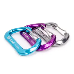 Three colorful carabiners are shown lined up. From left to right, the colors are blue, purple, and silver. Each carabiner has the text "Omega Pacific Lava Wiregate" printed on it. The carabiners feature a wire gate design.