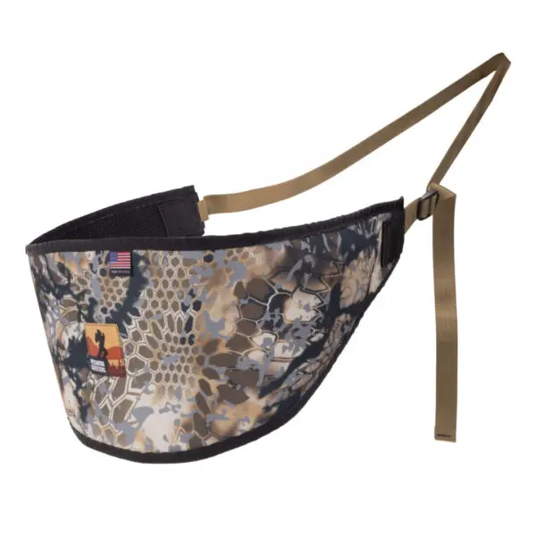 An Ape Canyon Outfitters Lazy Hunter Band Obskura Skyfall with brown adjustable straps and two patches sewn onto it—a small American flag and a rectangular patch with a silhouette of a bison inside a yellow and red state outline.