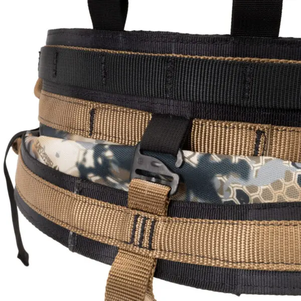 Close-up of a tactical belt with multiple straps and a plastic buckle. The Ape Canyon Outfitters Pioneer Saddle Obskura Skyfall With Cobra Pro Style Buckles has black, tan, and camo-patterned sections, and includes various loops and fastenings.