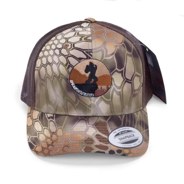 A camouflage-patterned Ape Canyon Outfitters Richardson Trucker Hat with a mesh back and an embroidered silhouette of a soldier on the front. The hat features a "Hi-Five" sticker labeled "AUTHENTIC SNAPBACK" on the visor, with additional tags attached to the side.