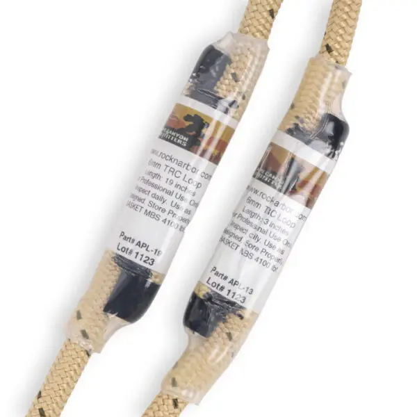 Two tan and black climbing ropes, labeled with barcodes and specifications, are twisted together. The labels include the brand "Ape Canyon Outfitters Sewn TRC Prusik Loop," part numbers "APL-16" and "APL-17," and manufacturing details. The ropes are wrapped in clear plastic.