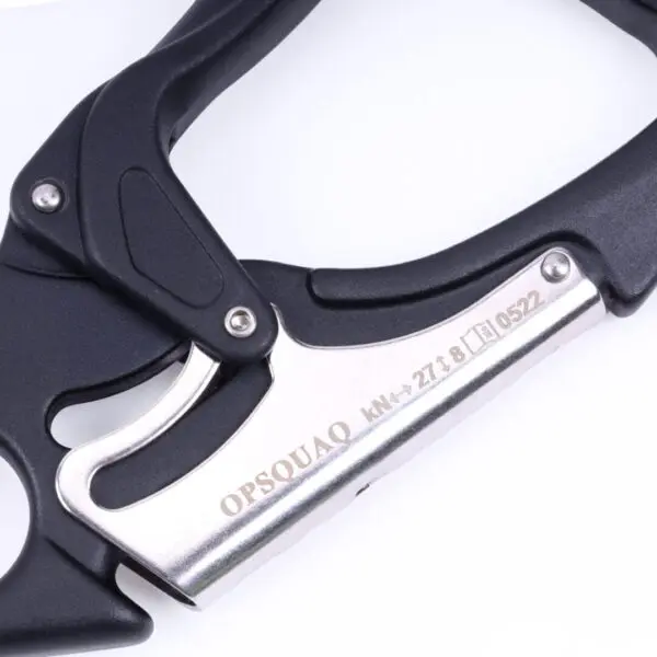 Close-up of a black and silver carabiner with the words "Omega Pacific Squatch Claw Aluminum Double Action Quik-Lok" and some alphanumeric characters engraved on the silver part. The carabiner features a sleek design with visible locking mechanisms.