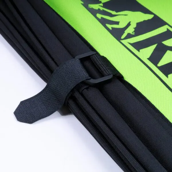 Close-up of a black adjustable strap with buckle on a RNA COLLAPSIBLE THROWLINE CUBE with graphical print.