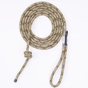 A coiled, camouflage-patterned Ape Canyon Outfitters 8mm Resc Tech Tree Tether with a knotted end and a loop at the other end, designed for outdoor activities and safety. The rope is visually secured with a plastic sheath near one end.