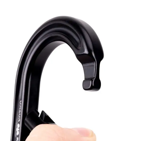 A close-up image of an Omega Pacific Raider Aluminum Keylock Straight Gate - Black being held by a person's fingers. The hook features a curved, robust design with a small notch at the top end. The background is completely white, highlighting the details of the carabiner.