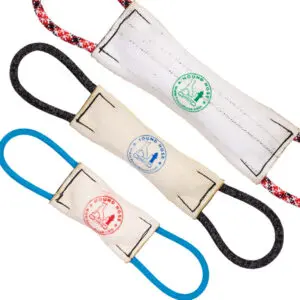 Three Hound Hose Dog Tug Toys are shown against a white background. Each toy has a cylindrical, fabric body with looped handles at both ends. They are color-coded with different loops: red and black, black, and blue. The fabric bodies have logos stamped on them.