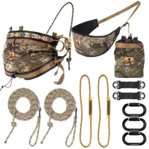 A camouflage hunting gear set featuring a harness, climbing ropes, carabiners, and accessories. The Ape Canyon Outfitters Pioneer Saddle Kit Obskura Transitional harness and accessories have a green and brown camouflage pattern, suitable for outdoor and hunting activities.