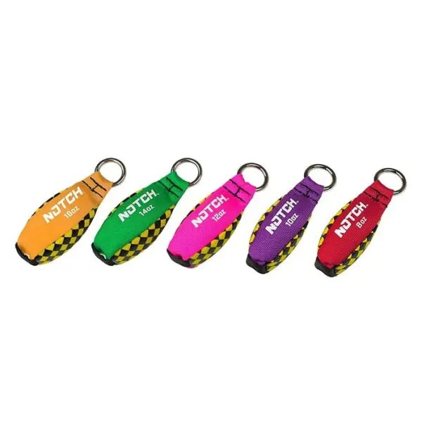 A set of five Notch Throw Weights in various colors: orange, green, pink, purple, and red. Each has a metal ring and a fabric tag with "NOTCH" text and weight details: 12oz on green, 16oz on orange, red, and purple, and 10oz on pink. Checkerboard patterns are at the bottom.