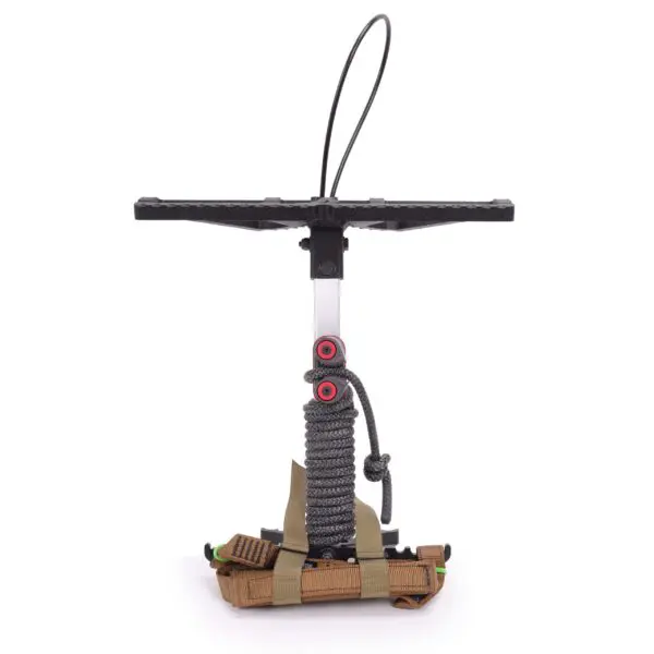 A compact, handheld air pump with a black T-shaped handle sits on a white background. The silver shaft is wrapped with a grey rope and adorned with red rings. The bottom part is secured with tan straps and features assorted small tools like pliers and a knife, resembling the Ape Canyon Outfitters Loaded Prospector One Stick.