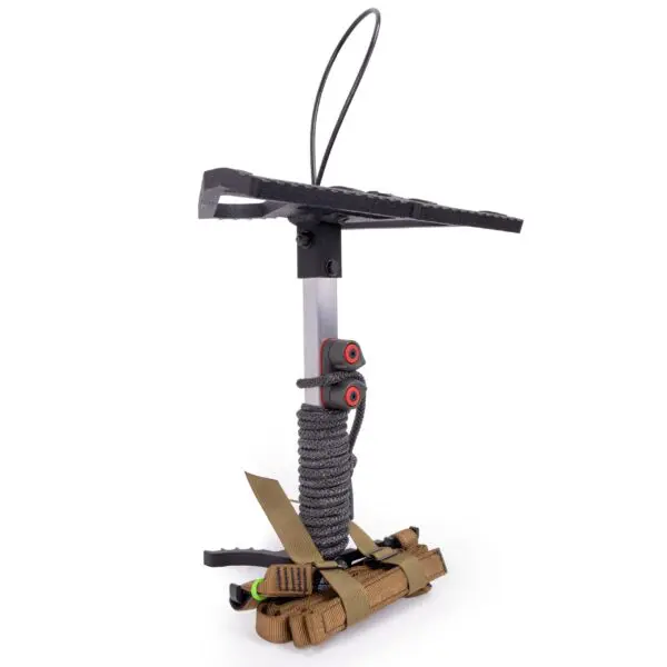 A compact, lightweight Ape Canyon Outfitters Loaded Prospector One Stick designed for hunting or climbing. It features a metal base with a padded rectangular platform, a strap for secure attachment, and a textured surface for grip. The step is wrapped with paracord, providing additional durability and utility.