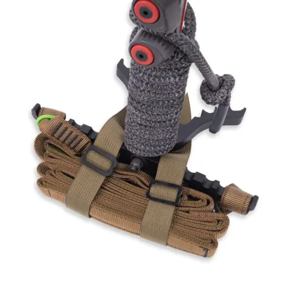 A neatly bundled rope package secured with tan straps. The top portion features a dark grey braided rope with red spool ends, alongside a knife in a holder. The entire setup appears to be organized for easy transport or storage, resembling the Ape Canyon Outfitters Loaded Prospector One Stick.