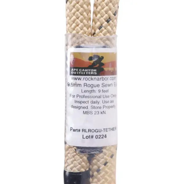 A close-up of a rope with a label from Ape Canyon Outfitters. The label mentions the rope's specifications: 9.5mm diameter, 9 feet length, for professional use only, inspect daily, and a maximum breaking strength (MBS) of 23 kN. Part #: RLROGU-TETHER, Lot#: 0224. Product Name: Ape Canyon Outfitters 9.5mm Rogue Tether