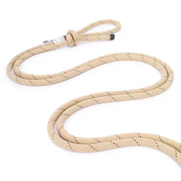A coiled, beige Ape Canyon Outfitters 9.5mm Rogue Tether with a knotted loop at one end is displayed on a white background. The rope has a black pattern woven into it.