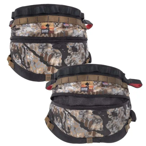Two Ape Canyon Outfitters Wood Deluxe Saddle Obskura Skyfall with adjustable straps and multiple compartments displayed side by side. The design features a mix of earthy tones for blending into natural environments, suitable for outdoor or military use.