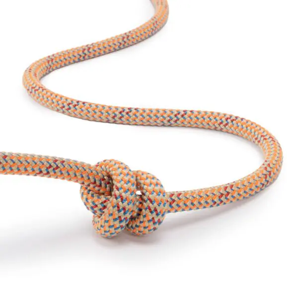 A multi-colored, braided rope with orange, blue, and white strands is tied into a single knot on one end, with the rest of the rope forming a loose coil on a white background. This is the Ape Canyon Outfitters 9mm Canyon Elite Tether.