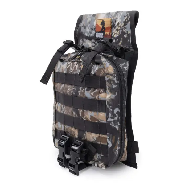 A camouflage-patterned tactical backpack with multiple straps, buckles, and MOLLE webbing on the front. The top flap displays a patch with a silhouette of a soldier and text reading "Wounded Warrior Project." The Ape Canyon Outfitters Canyon Quiver Highlander is designed for utility and durability.