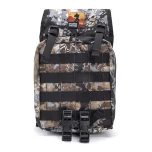 An Ape Canyon Outfitters Canyon Quiver Highlander with multiple black straps and buckles on the front. The top of the backpack features a patch with an outdoor logo. The bag has a rugged design, suitable for outdoor activities.