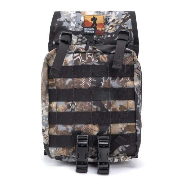An Ape Canyon Outfitters Canyon Quiver Highlander with multiple black straps and buckles on the front. The top of the backpack features a patch with an outdoor logo. The bag has a rugged design, suitable for outdoor activities.