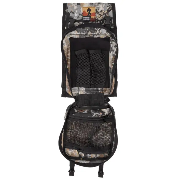 An Ape Canyon Outfitters Canyon Quiver Highlander is shown partially unzipped, revealing multiple compartments and pockets for storage. The inside of the top flap has a rectangular patch with an image of a moose and text that reads "MOOSE RIVER." The backpack is laid flat on a white background.