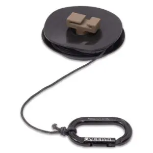Image showing a black plastic spool with a gray rectangular attachment on top, holding a thin cord. The cord extends from the spool and is connected to an Ape Canyon Outfitters One Stick Retrieval Donut With Post at the end.