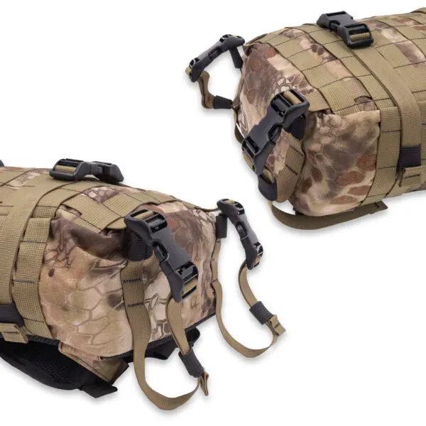 Two tan and camouflage-patterned Ape Canyon Outfitters Conclave Pack Highlander backpacks are displayed. Each backpack has multiple adjustable straps, buckles, and MOLLE webbing for attaching additional gear. One backpack is shown from the top view, and the other from the side view.