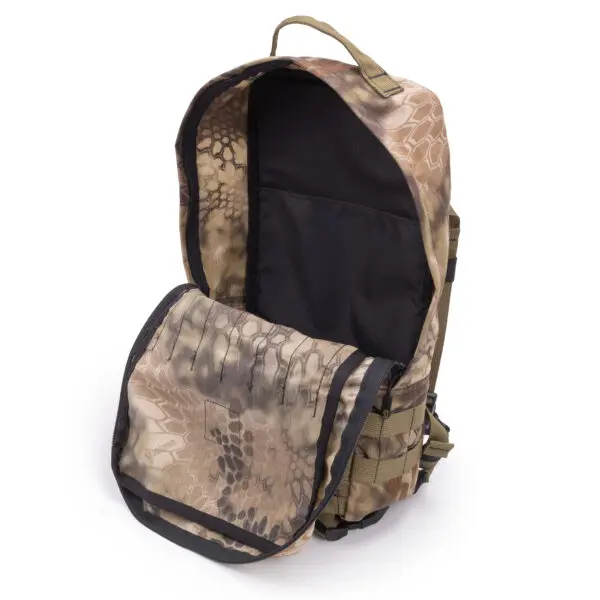 An Ape Canyon Outfitters Conclave Pack Highlander with its main compartment open, revealing a black interior lining. The front flap of the backpack is also open, displaying additional camouflage design. The bag features a handle on top and black zippers.