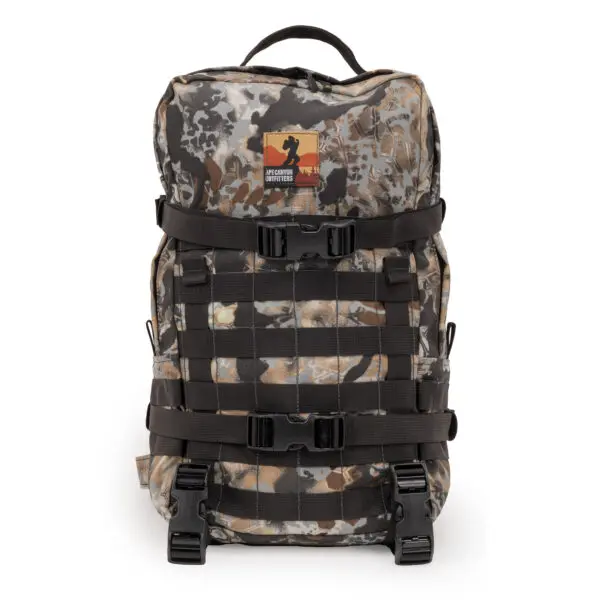 A rugged camouflage Ape Canyon Outfitters Conclave Pack Highlander Skyfall with multiple black straps and buckles. The bag features an orange and black patch with a silhouette logo and text near the top. Perfect for outdoor activities and adventures.