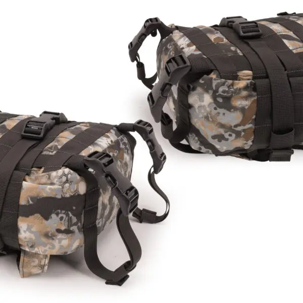 Two **Ape Canyon Outfitters Conclave Pack Highlander Skyfall** with black straps and buckles are placed side by side against a white background. The bags have adjustable straps and are suitable for outdoor activities.