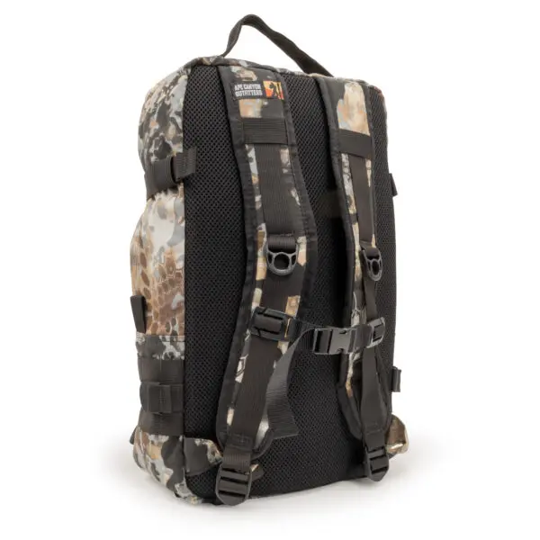 An Ape Canyon Outfitters Conclave Pack Highlander Skyfall with padded black mesh straps, chest strap, and adjustable side straps. The top handle features a small label with text. The backpack has multiple compartments and a sleek, rugged design suitable for outdoor activities.
