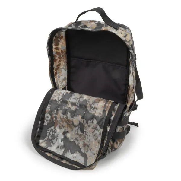 A camouflage-patterned Ape Canyon Outfitters Conclave Pack Highlander Skyfall with an open main compartment and front flap, displaying a large internal pocket and black lining. The backpack is set against a white background.