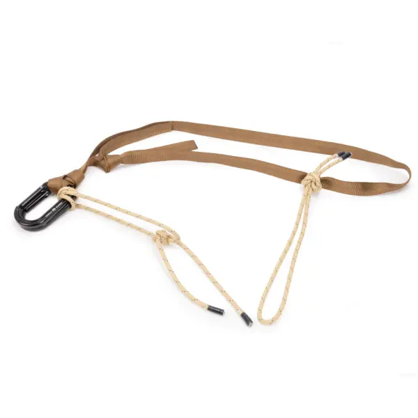 A JRB Garda Hitch Footloop Kit with a tan adjustable strap and two beige rope loops with black ends, designed for climbing or securing heavy loads. The harness features a black carabiner for attachment. The image is set against a plain white background.