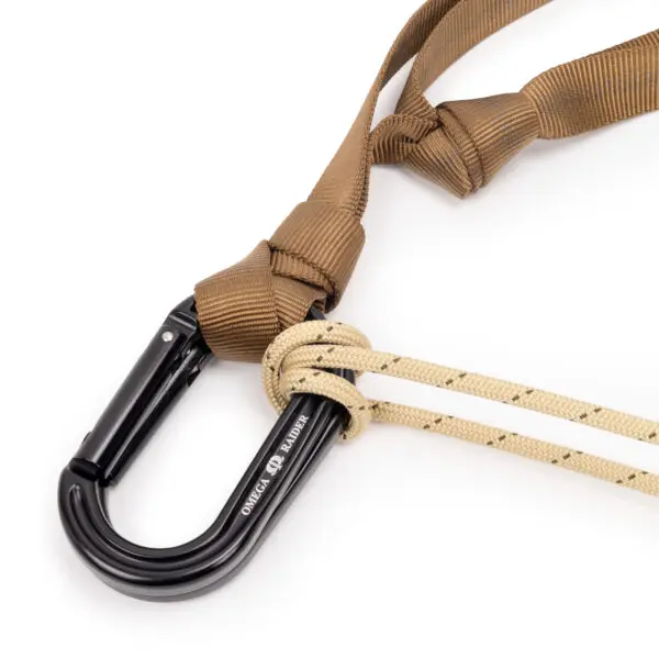 A JRB Garda Hitch Footloop Kit attached to a beige climbing rope and a brown strap. The footloop kit has the text "Omega Pacific" engraved on it. The rope has a knot securing it to the footloop kit, ensuring a strong connection.