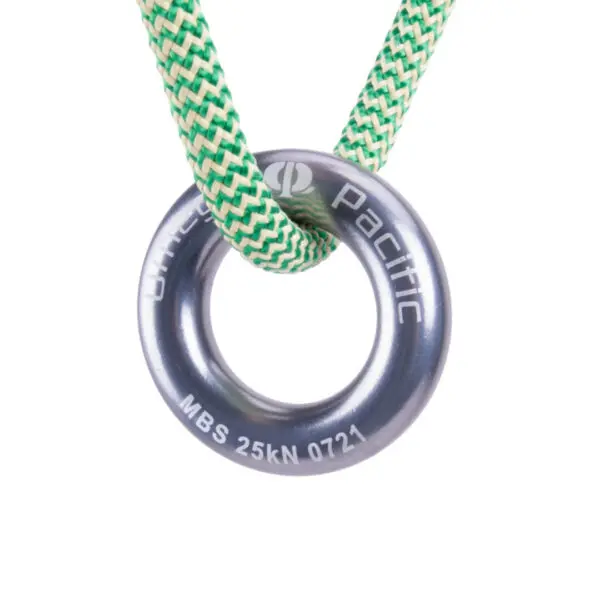 A green and white braided rope is threaded through an Omega Pacific Aluminum Rappel Ring, which is engraved with "Ollivier Pacific" and "MBS 25kN 0721." The setup appears to be equipment for climbing or rigging, set against a white background.