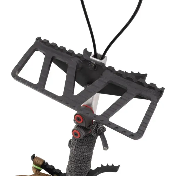 A close-up image depicting a Scout One Stick step, showcasing its black color with triangular cutouts that reduce weight. The step is equipped with red spacers and has a section wrapped in textured material for enhanced grip. Black cables are attached to the top of the step, extending upwards.