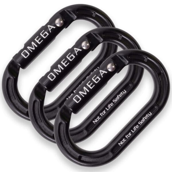 Three black Omega Pacific Micro Raider Aluminum Keylock Straightgate carabiners with "OMEGA" and "Not for Life Safety" printed on them are arranged in a slightly overlapping manner. The carabiners are oval-shaped and feature a screw-lock mechanism.