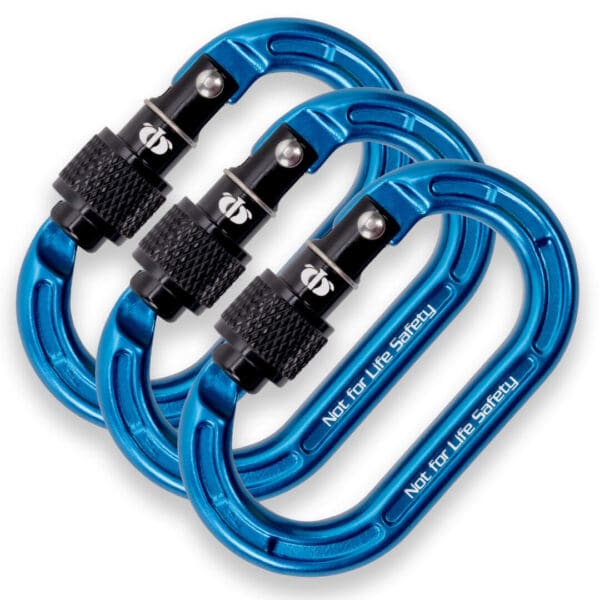 Three blue Omega Pacific Micro Raider Aluminum Keylock Screw-Lok with black locking mechanisms are arranged in a fanned-out formation. The carabiners have "Not for Life Safety" inscribed on them, indicating they are not intended for climbing or safety-critical uses.