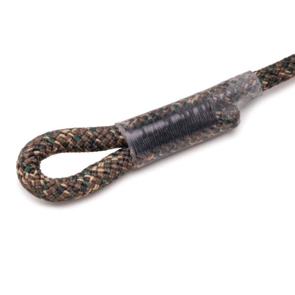 A close-up view of a looped end of an Ape Canyon Outfitters 9.5mm Lineman Belt with a camouflage pattern. The loop is reinforced with a tightly wrapped section of clear plastic to secure it. The belt's texture and detailed weaving are clearly visible.