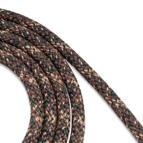 Close-up of a coiled, tightly braided Ape Canyon Outfitters 9.5mm Lineman Belt with a camouflage-like pattern in shades of brown, tan, and dark green. The belt's texture appears durable and sturdy, suggesting it's designed for outdoor or heavy-duty use.