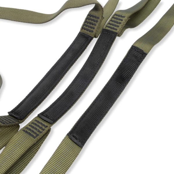 A close-up image of green and black straps with reinforced stitching. The Ape Canyon Outfitters 3 Step Aider has loops at the ends and textured areas, likely designed for added grip or durability. The background is white.