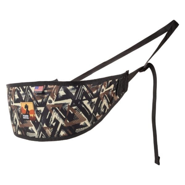 A camouflage-patterned archery arm guard with an adjustable black strap. It features the Bohning company logo near an American flag patch. The Ape Canyon Outfitters Lazy Hunter Band WTFCAMO is primarily brown, beige, black, and white, with geometric shapes creating the camo pattern.